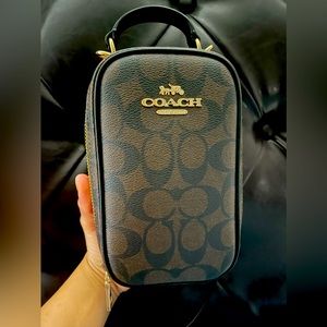 Coach cross body bag holds phone and wallet and a little snack comfortably